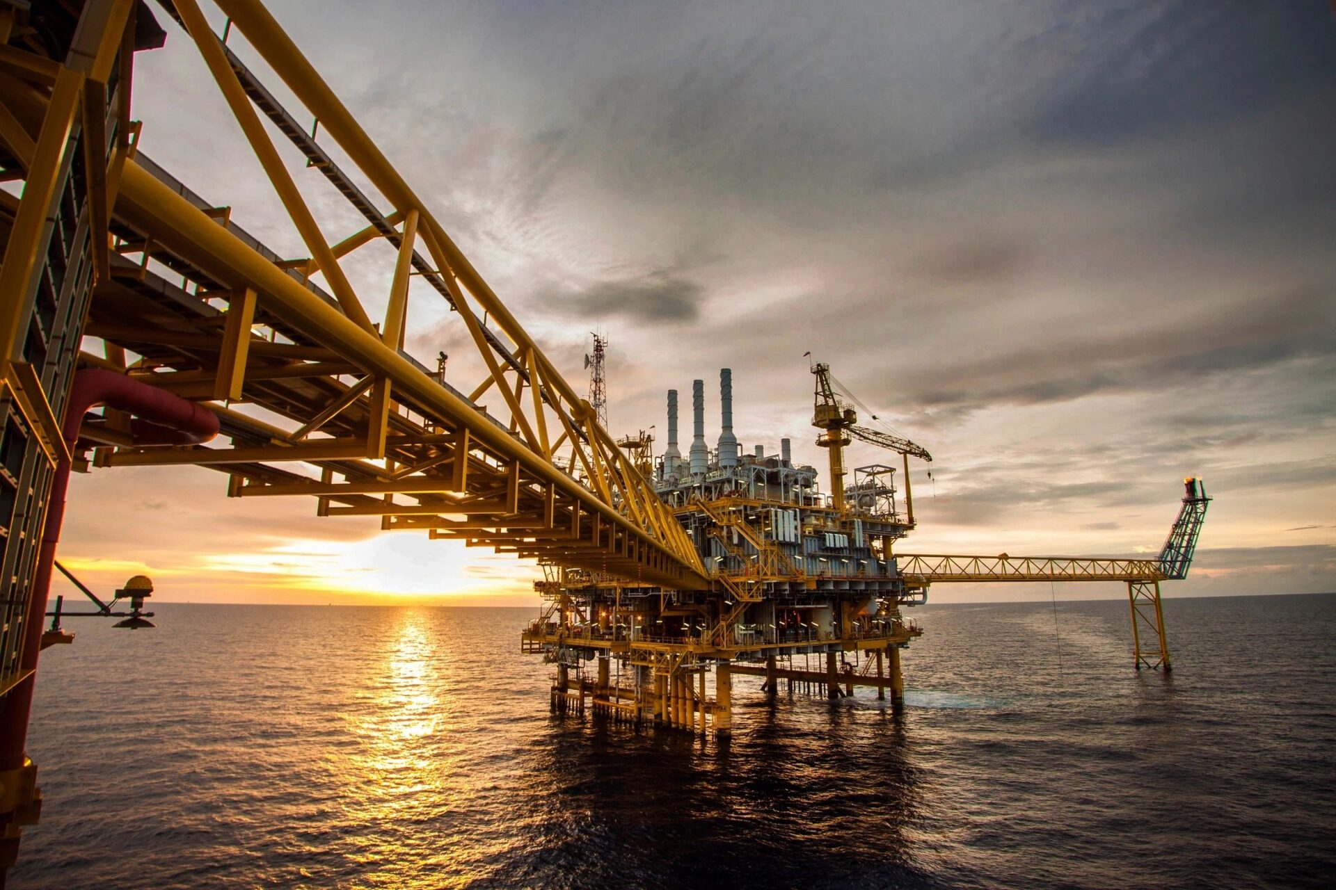 A large oil rig in the middle of an ocean.